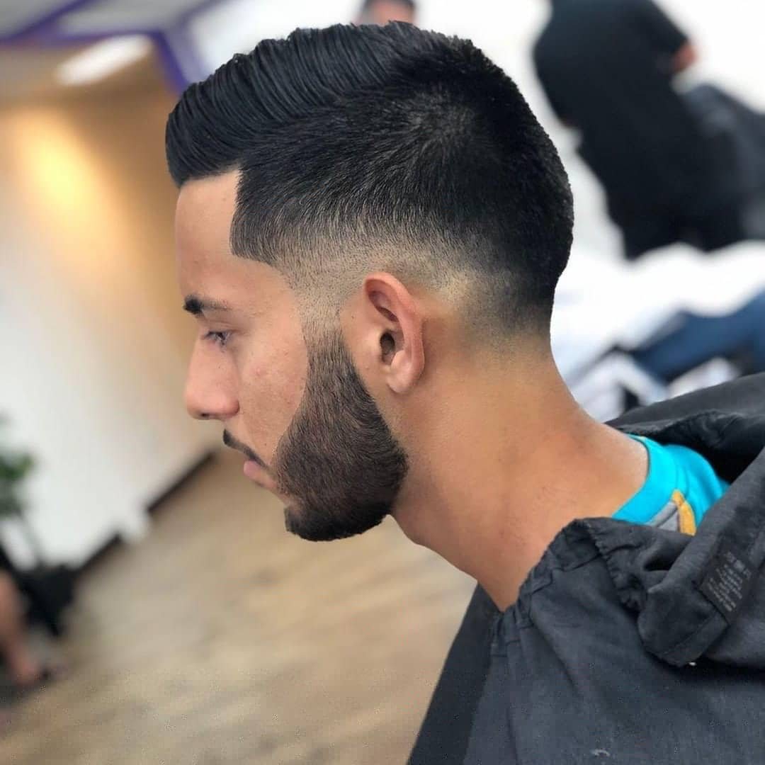 Mid fade with beard blend and pompadour